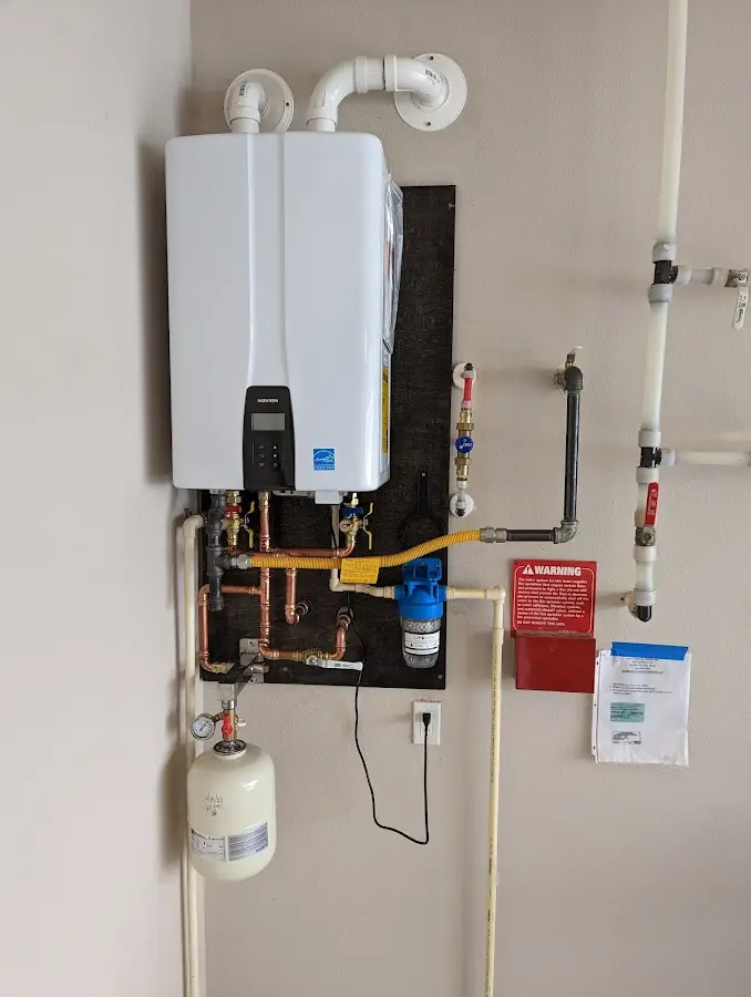 Professional plumber installing copper piping in a Tri-City home